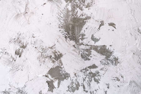 Abstract background from white concrete texture with cracked and scratched and strokes of plaster.の写真素材