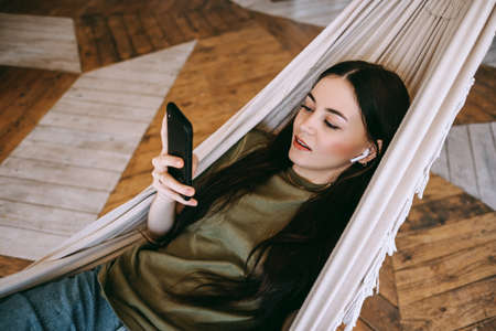 Attractive happy young woman relaxing in the home