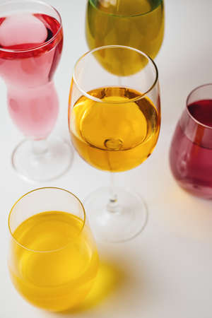Glasses with multi-colored drinks on a white background. High quality photoの写真素材