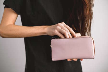 Young woman takes out money from a wallet. Close up. High quality photo