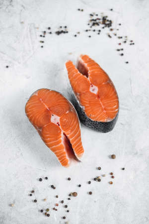 Fresh steaks of red salmon fish with spices in a gray background. High quality photoの写真素材