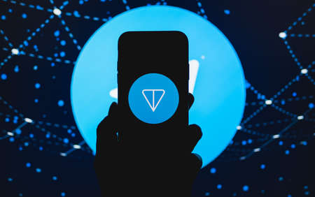 TON logo on the smartphone screen. Ton is a blockchain platform from telegram. High quality photoのeditorial素材