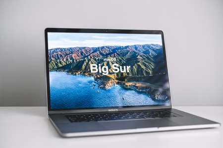 MacBook with Mac OS Big Sur background logo on the screen, new operating system which will be...
