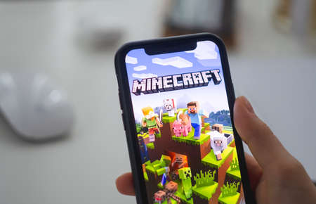 Minecraft game on the iPhone screen in hand. High quality photoのeditorial素材