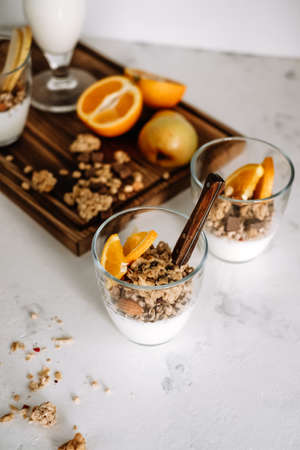 Natural yogurt and granola with slices of fruits and nuts in a glass cup, healthy breakfast .. High quality photoの写真素材