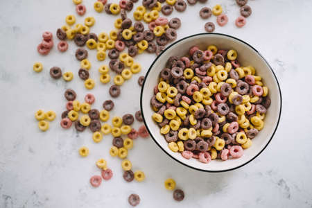 Multi-colored corn rings on a white bowl for breakfast, healthy food. High quality photoの写真素材