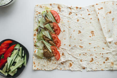 Cooking chicken roll with meat, fresh vegetables, herbs and sauce. High quality photoの写真素材
