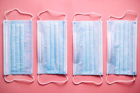 Group of medical protective masks in isolated on pink background. Medical mask protection against pollution, virus, flu, coughing and coronavirus. High quality photoの写真素材