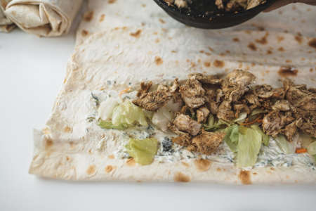 Cooking chicken roll with meat, fresh vegetables, herbs and sauce. High quality photoの写真素材