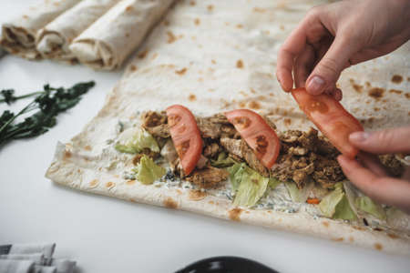 Cooking chicken roll with meat, fresh vegetables, herbs and sauce. High quality photoの写真素材