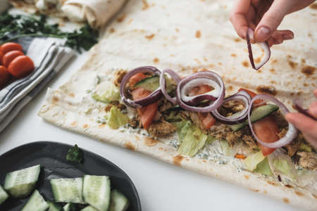Cooking chicken roll with meat, fresh vegetables, herbs and sauce. High quality photoの写真素材
