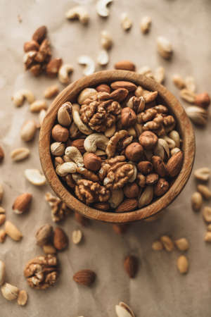 Different types of nuts, nut mix of almonds, hazelnuts, cashews, peanuts in a wooden bowl. Close up. High quality photoの写真素材