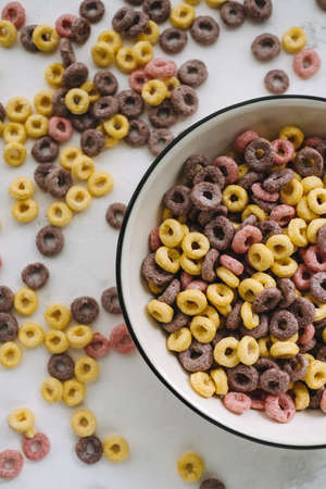 Multi-colored corn rings on a white bowl for breakfast, healthy food. High quality photoの写真素材