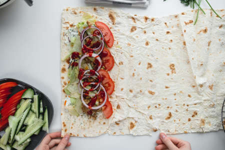 Cooking chicken roll with meat, fresh vegetables, herbs and sauce. High quality photoの写真素材