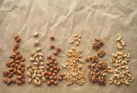 Different types of nuts, nut mix of almonds, hazelnuts, cashews, peanuts on a craft paper. High quality photoの写真素材