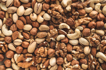 Different types of nuts, nut mix of almonds, hazelnuts, cashews, peanuts texture background. Close up. High quality photoの写真素材