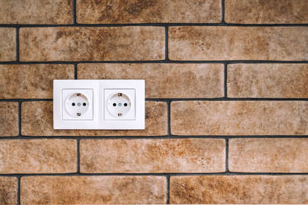 Power socket on the stone brick wall with copy space. High quality photoの写真素材
