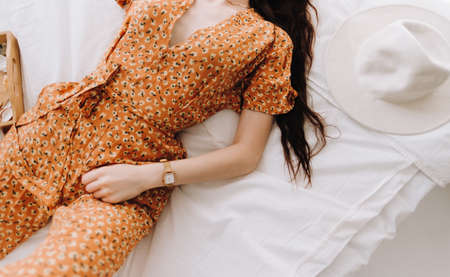 Beautiful young stylish woman lying on bed in sunny morning. High quality photoの写真素材