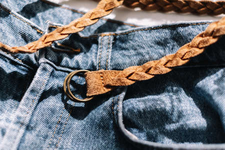 Stylish Leather Braided Brown Belt On Blue Jeans. High quality photoの写真素材