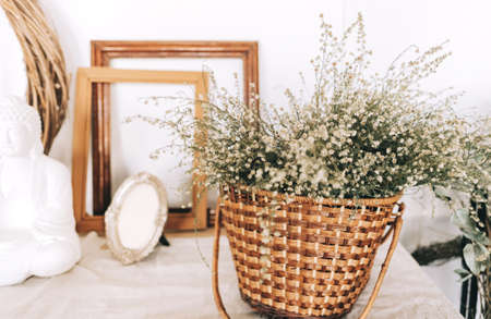 Wicker basket with dried flowers bouquet on the table. High quality photo
