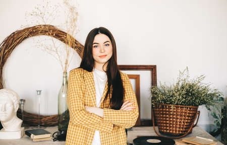 Portrait of successful beautiful woman art designer, decorator standing in studio office. High...