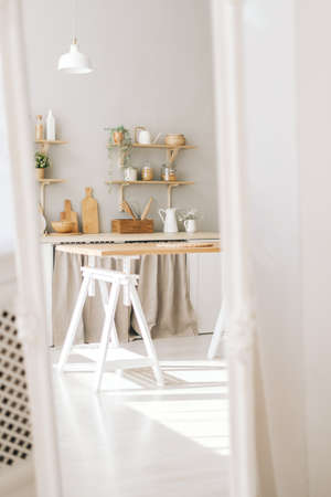 Mirror reflection of bright kitchen in the Provence style with houseplants, wooden dishes and...