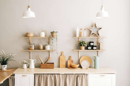 Bright kitchen in the Provence style with houseplants, dishes and kitchen accessories on the table...