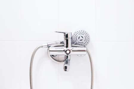 Hand shower on the white wall in bathroom. High quality photoの写真素材
