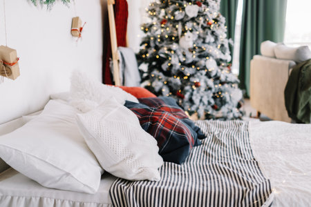 Bedroom interior with large bed and christmas tree with decorations. High quality photoの写真素材