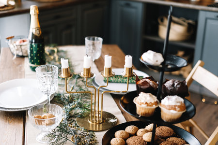 Festive Christmas table with sweet cookies and cakes in the kitchen with decorations. High quality photoの写真素材