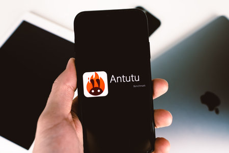 hand holds smartphone with Antutu benchmark logo on the screen. High quality photoのeditorial素材