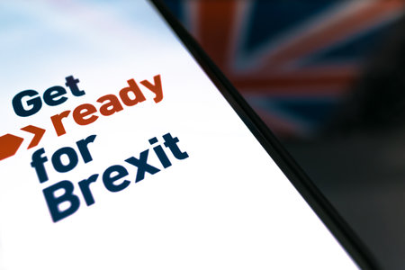 Hand holds smartphone with text. Get ready for Brexit.