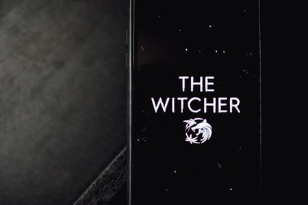 The Witcher from Netflix TV series Poster, the iPhone with shot of The Witcher.