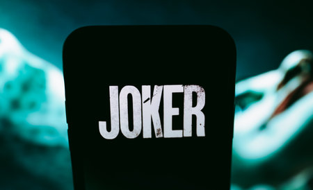 iPhone X with Joker Movie logo poster 2019 on the screen. Copy space.のeditorial素材