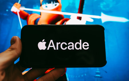 hand holding the iPhone with apple arcade logo on the screen. High quality photoのeditorial素材