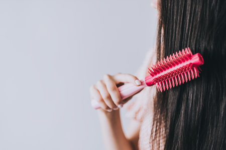 Hair Care. Hair brushing Healthy Straight Brown Hair. Young Woman Brushing Her Long Hair With Comb. Health And Beauty Concept.の写真素材