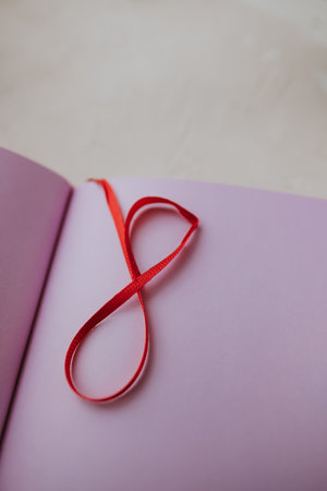 Bookmark in the notebook in the form of figure eight, women's day concept. High quality photo.の写真素材