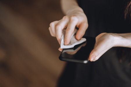 Cleaning the smartphone screen with a fiber cloth from dirt dust and other external factors. Germs...