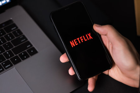 Netflix logo on smartphone screen. High quality photo.