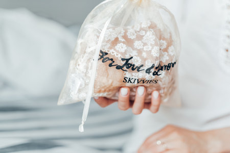 For Love and Lemons brand, girl holding a bag with women's underwear, pastel colors