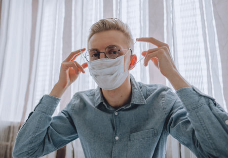 Young man in medical protective mask, quarantine concept.の写真素材