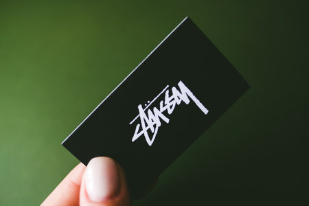 Closeup of Stussy logo label on green background.のeditorial素材