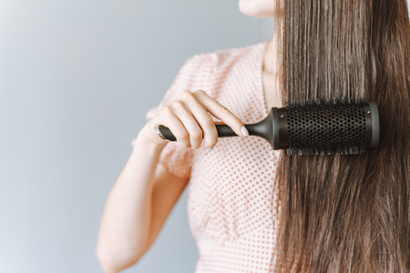 Hair Care. Hair brushing Healthy Straight Brown Hair. Young Woman Brushing Her Long Hair With Comb. Health And Beauty Concept.の写真素材