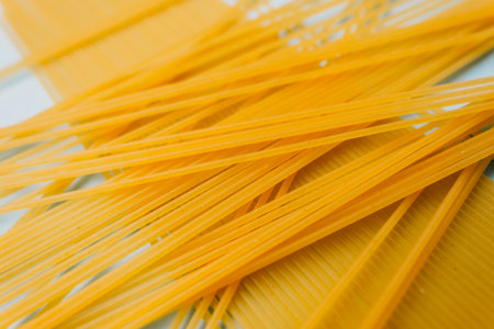 Wheat pasta spaghetti isolated on a blue background. Top view.の写真素材
