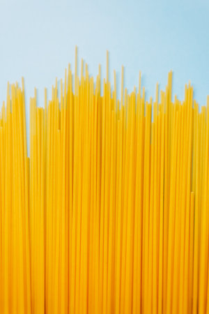 Wheat pasta spaghetti isolated on a blue background. Top view.