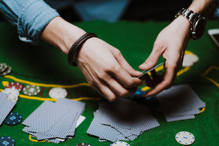 Croupier holds playing cards, game chips on the table. Poker concept.の写真素材