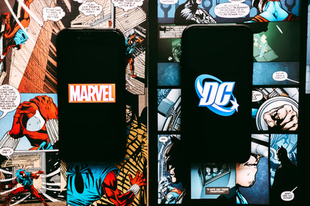 Marvel and DC comics logo on the comics page background.のeditorial素材