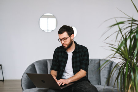 Young caucasian businessman work at home, freelance work, use laptop computer. High quality photoの写真素材