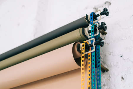 Paper backgrounds system on the wall in photo studio, close-up.の写真素材