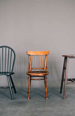 Group of different vintage wooden chairs on gray background.の写真素材